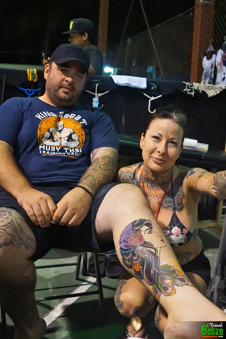 Tattoo Artist Madison Stone proudly poses next to her work of art at the end of the Tattoo Expo